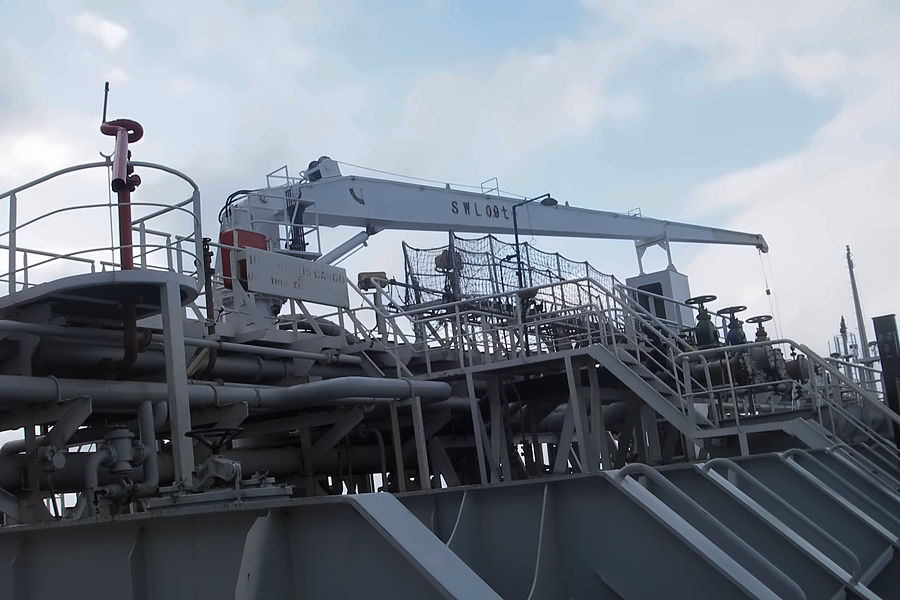 A ship's deck crane, manifold pipework and access platforms
